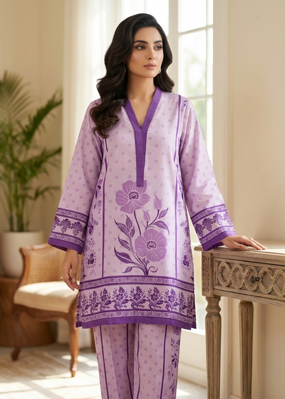 Woman wearing a purple embroidered outfit in a well-lit room.